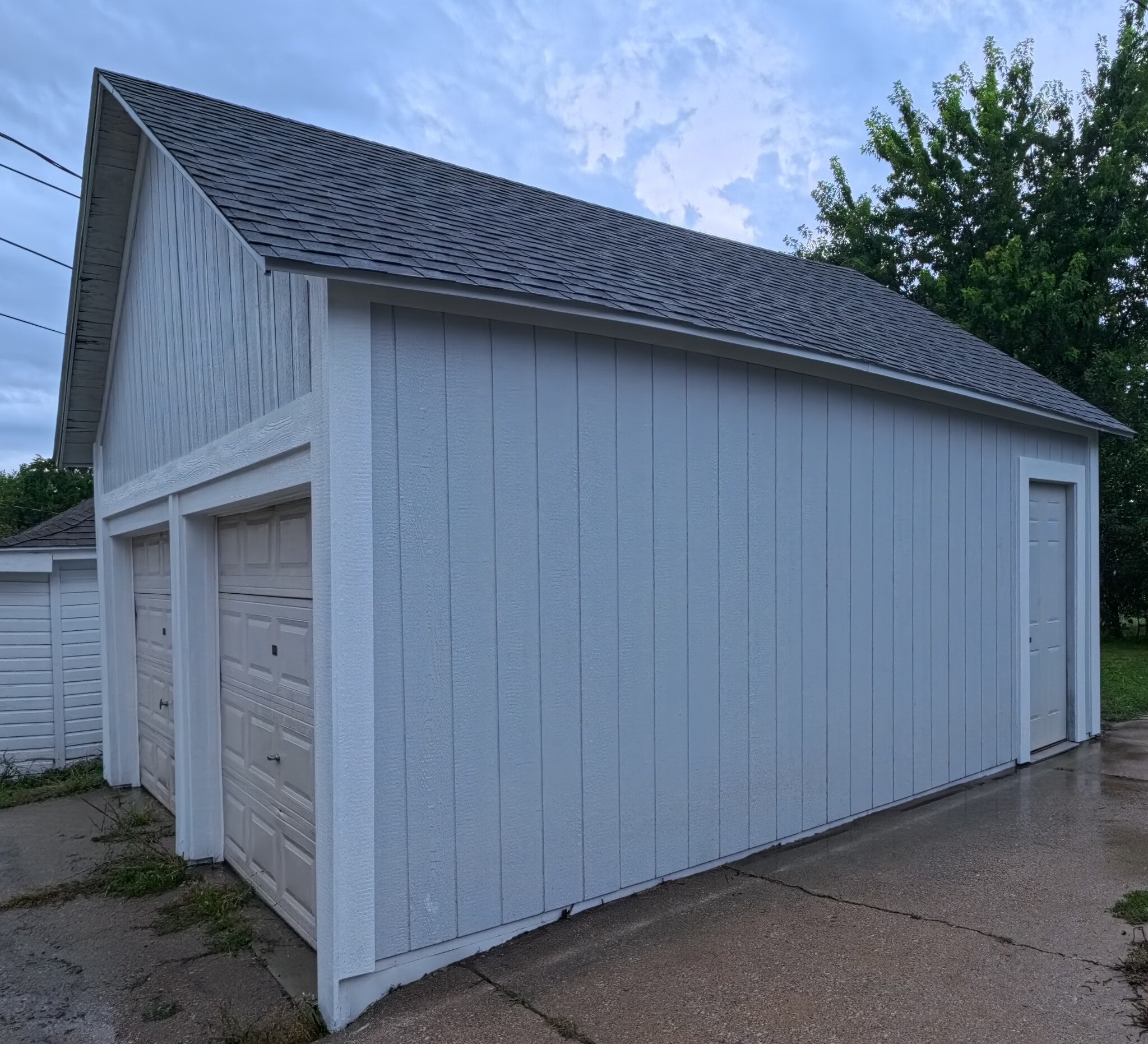 Completed detached garage with LP SmartSide vertical panel siding and coordinated trim