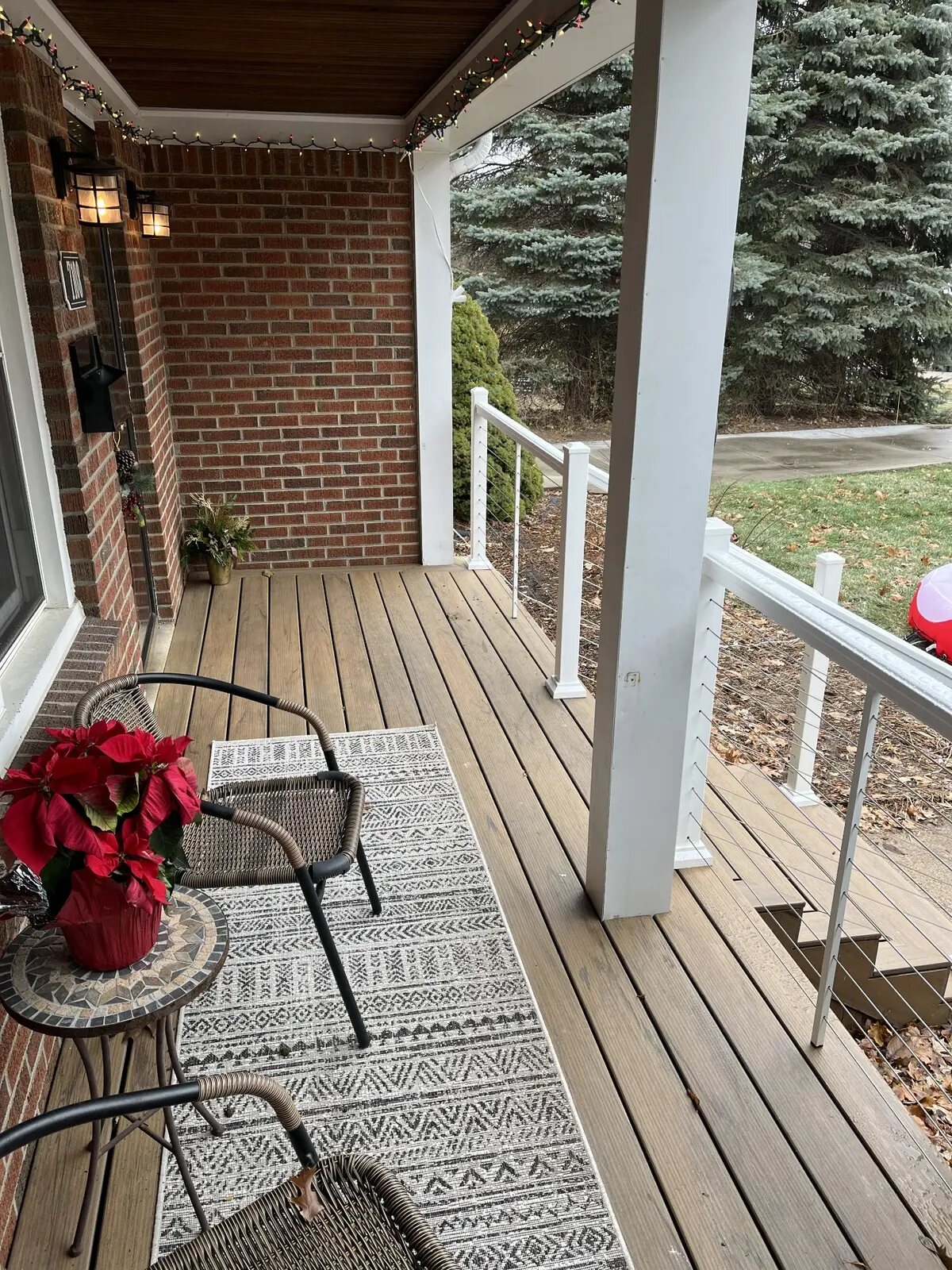 Renovated porch with composite decking and cable railing