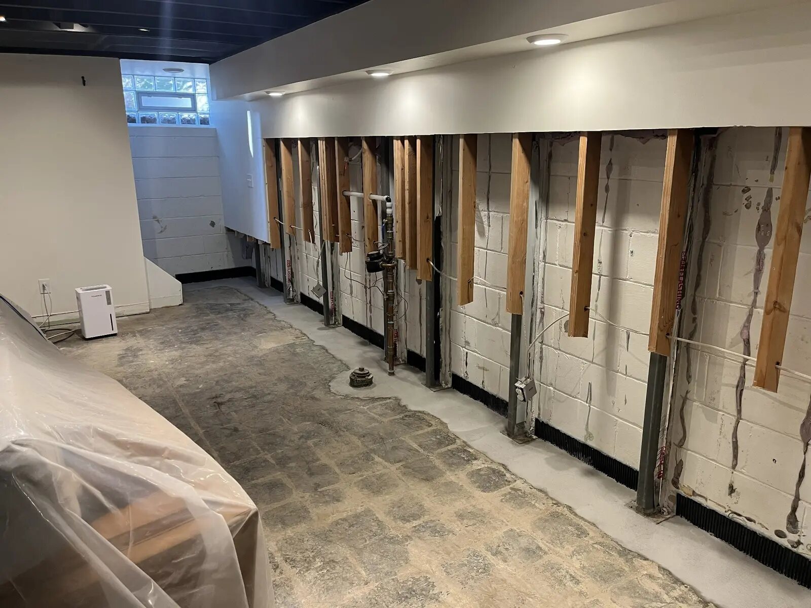 Basement during water restoration and sump pit installation